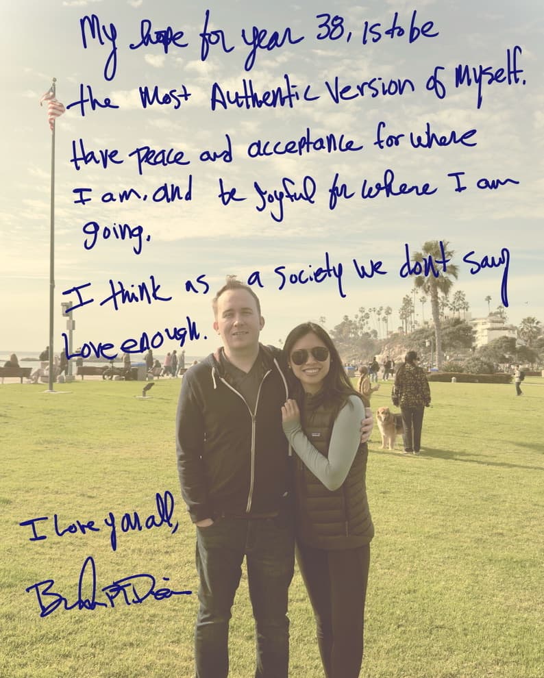 A handwritten birthday note over a photograph of Brandon PT Davis and his partner standing near the ocean.