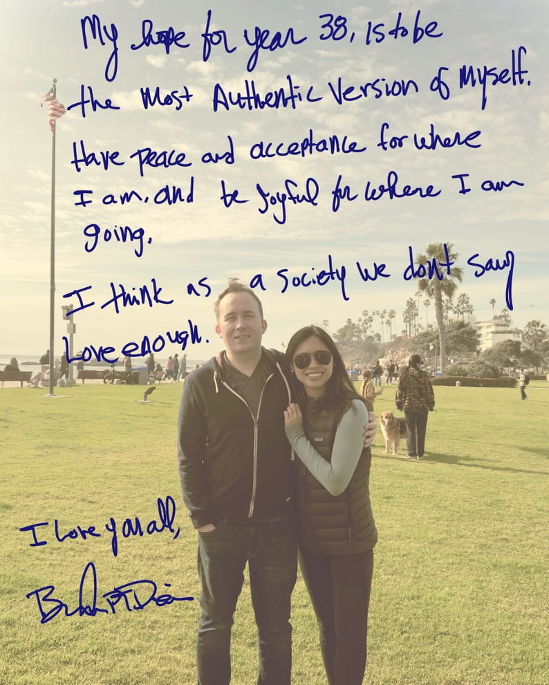 A handwritten birthday note over a photograph of Brandon PT Davis and his partner standing near the ocean.