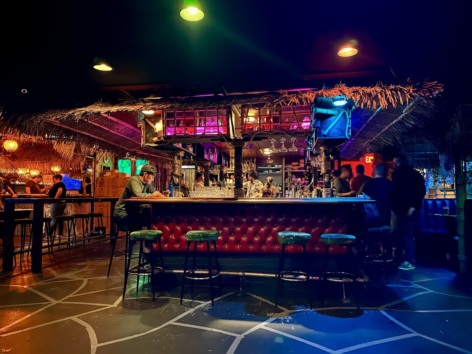 Tiki-inspired restaurant interior with layered decor, warm lighting, and immersive themed details.