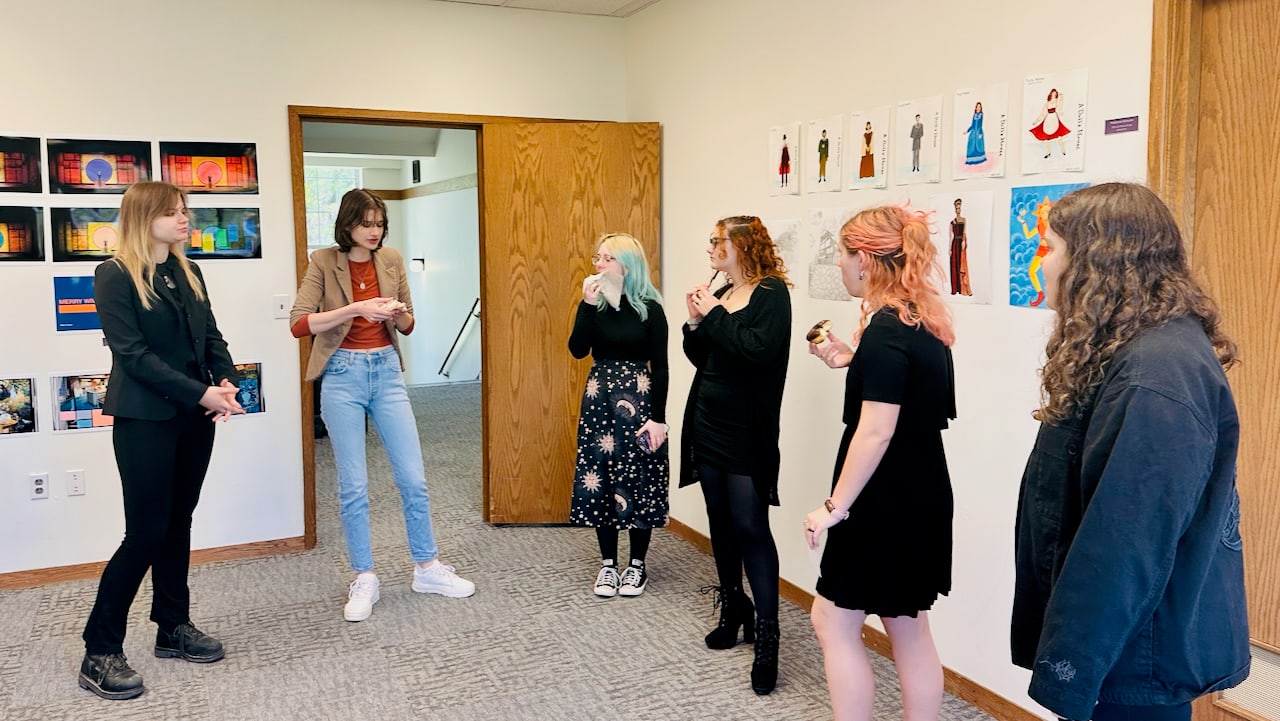Students discussing design work during a studio critique