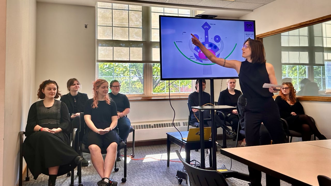 Student presenting a design diagram to a classroom group
