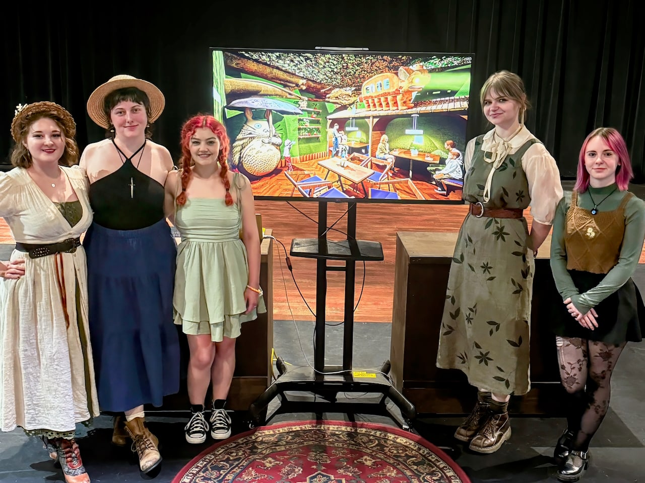 Students presenting scenic design work during a studio conversation