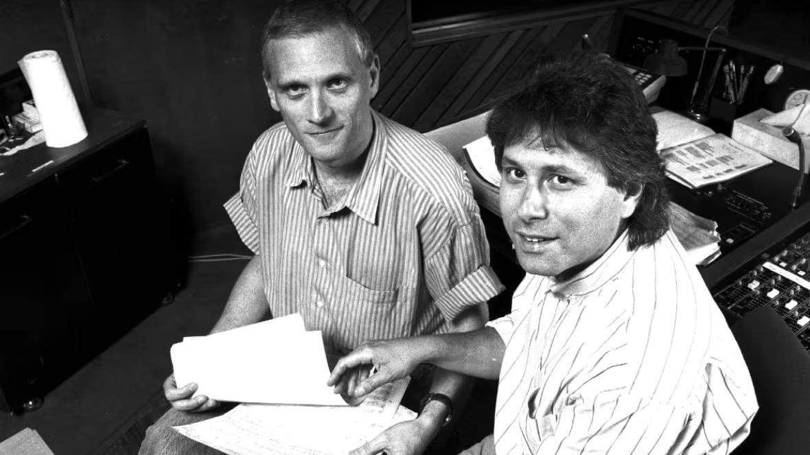 Alan Menken and Howard Ashman at a recording desk.