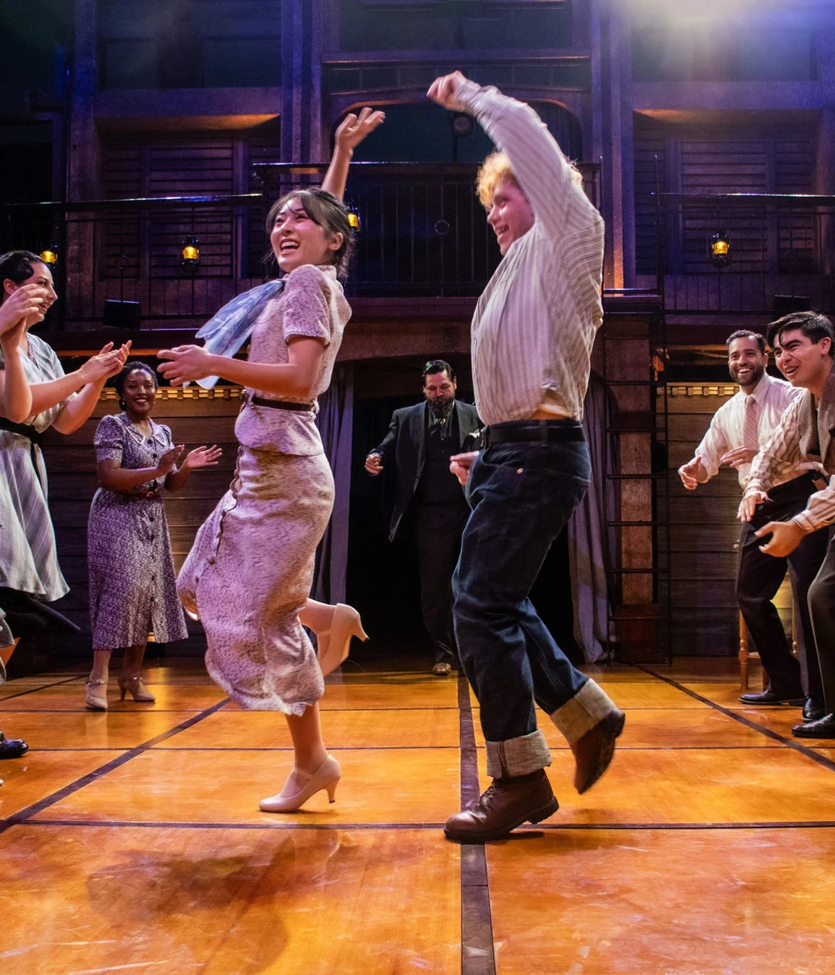 The ensemble dances across the open floor of the Great Depression-era scenic design for Romeo and Juliet for Romeo & Juliet at New Swan Theatre Company.