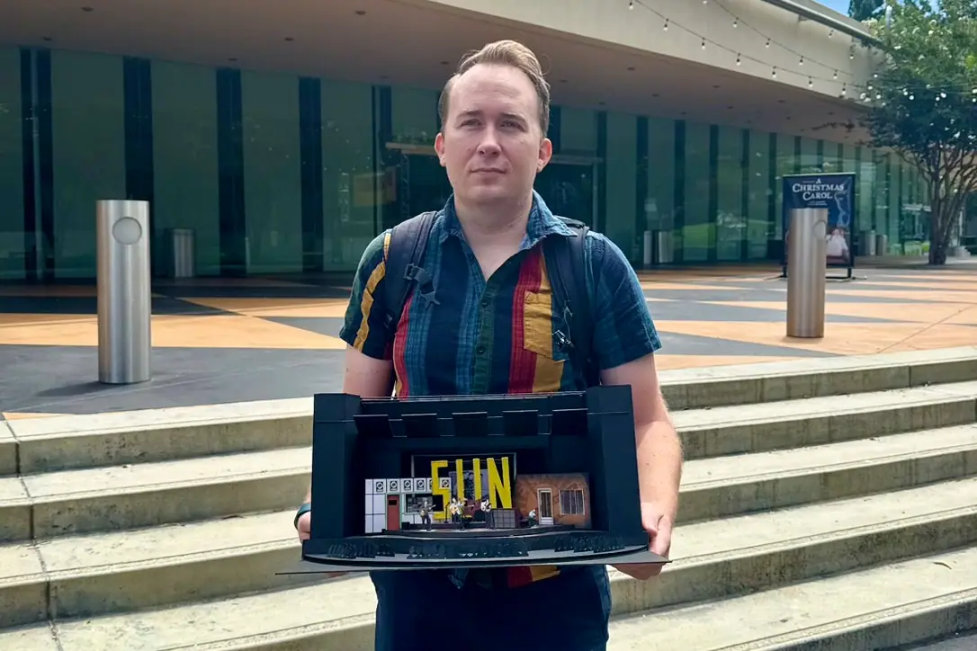 Brandon PT Davis holding a scenic model