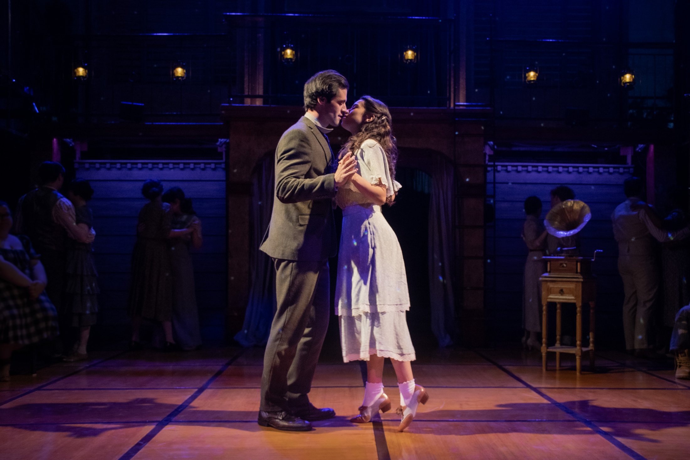 Romeo and Juliet share an intimate moment at the center of the open in-the-round stage.