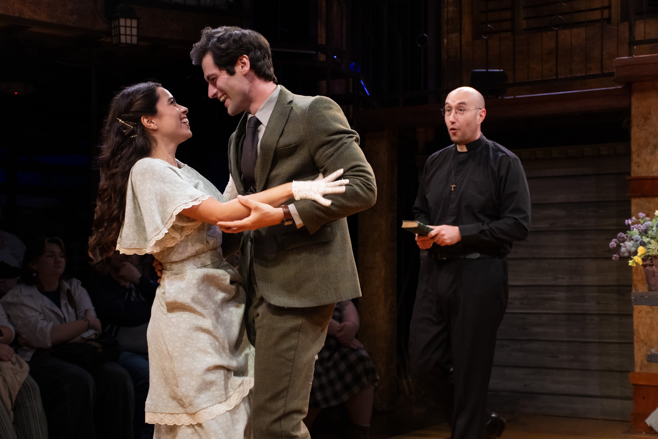Romeo and Juliet perform at close range with the audience visible around the stage.