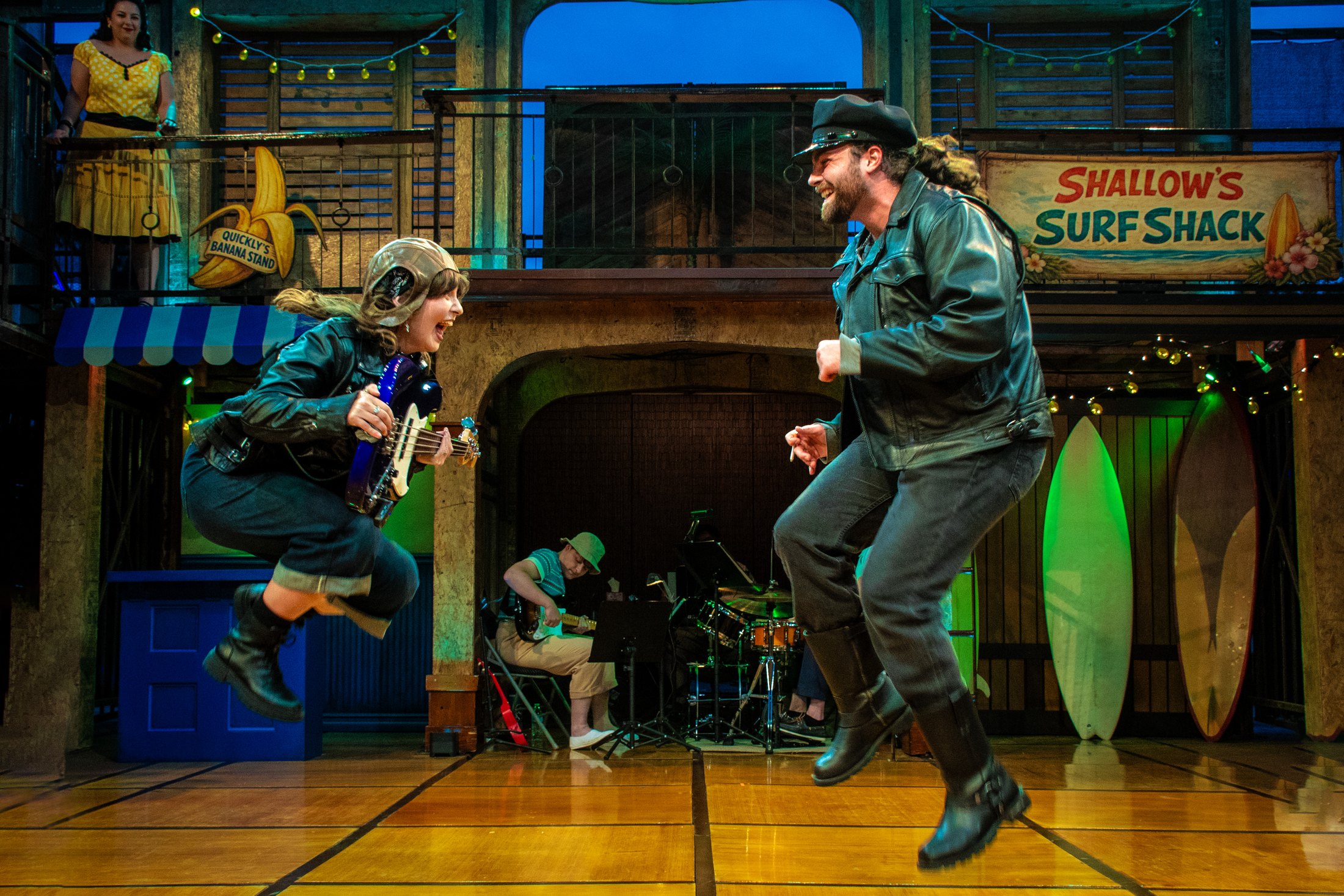 Two performers dance in front of Shallow’s Surf Shack in Windsor Cove.
