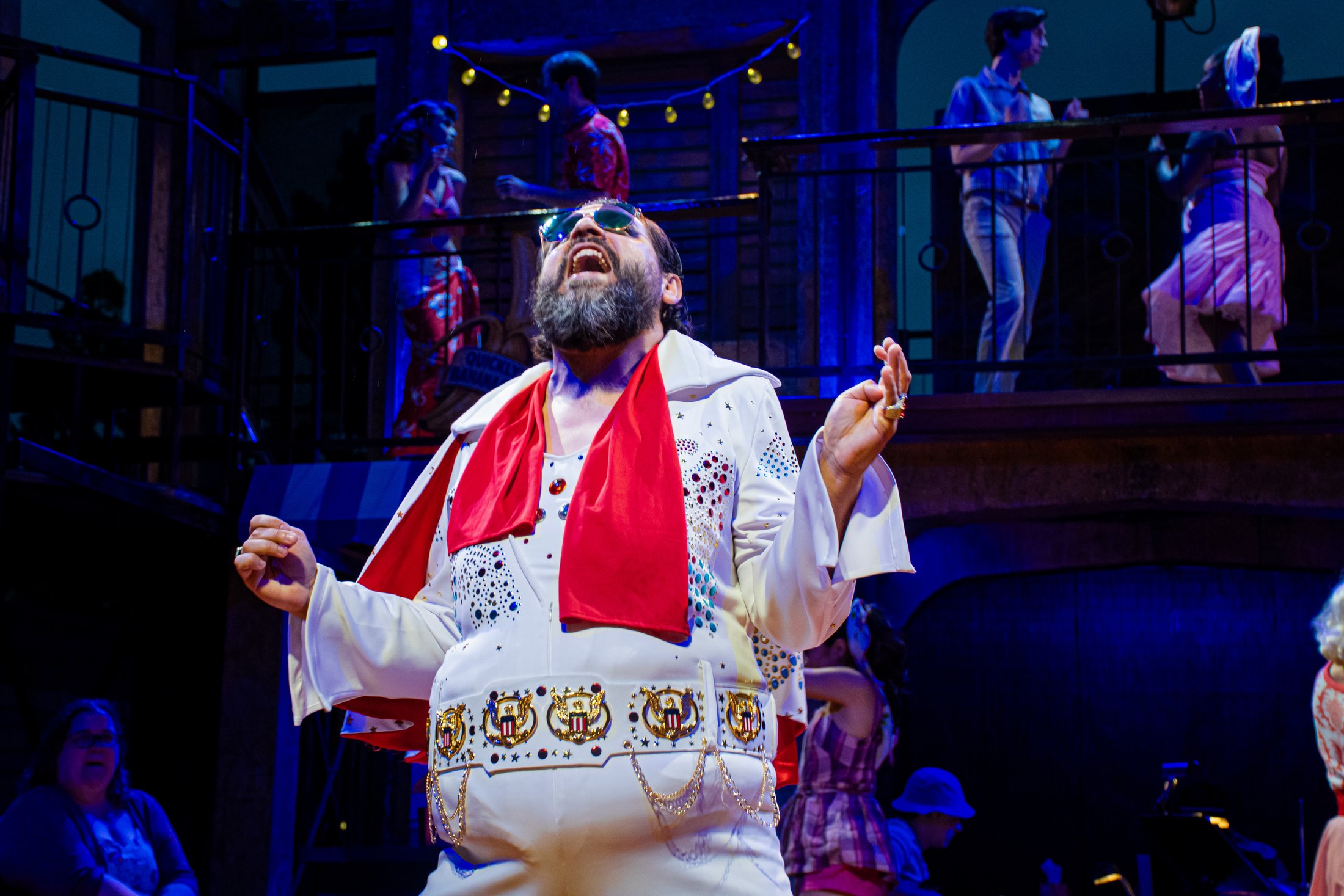 Johnny Falstaff performs against the surf-town architecture and upper gallery.