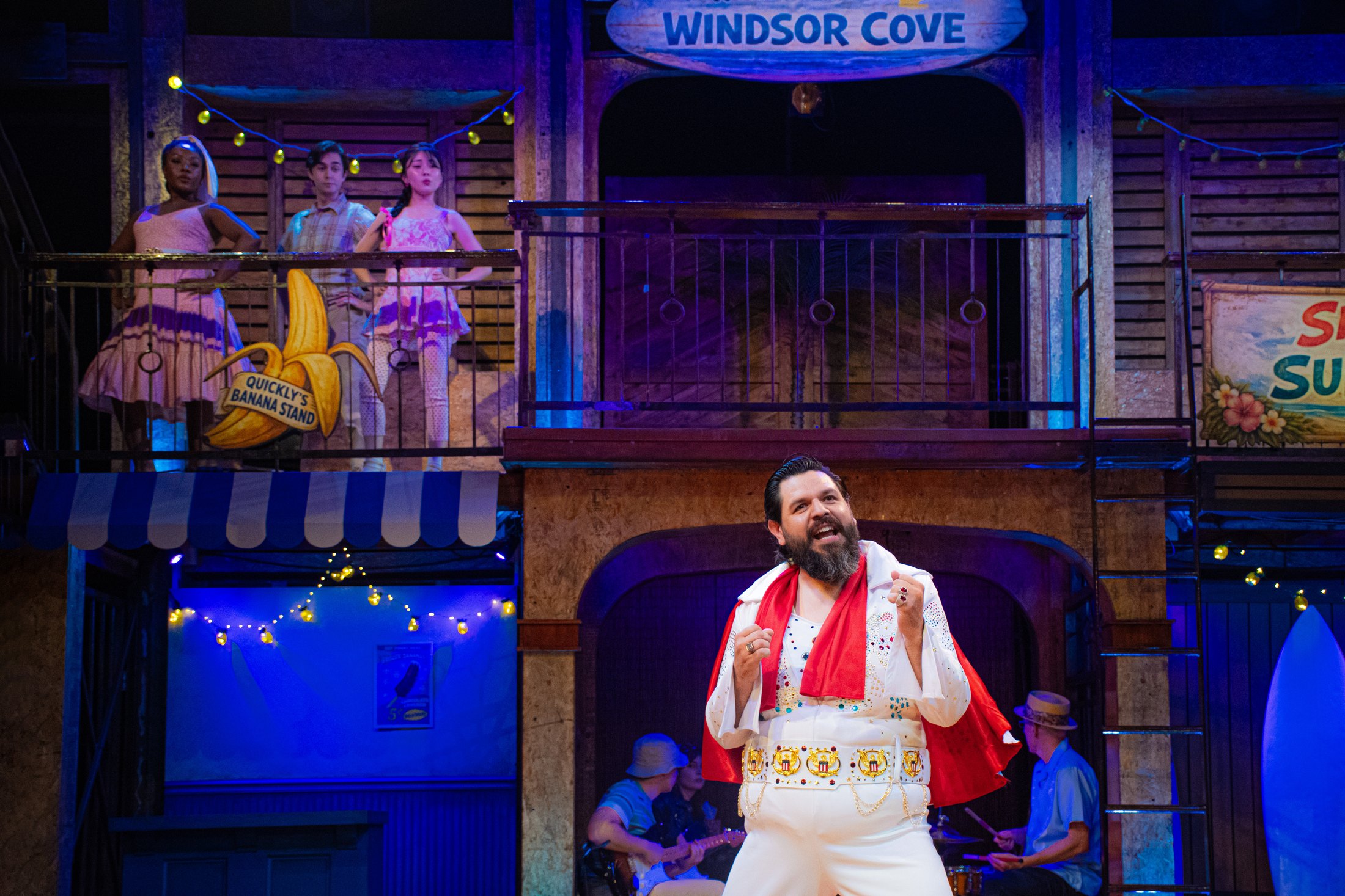 Johnny Falstaff performs beneath the graphic Windsor Cove beach-town signage.