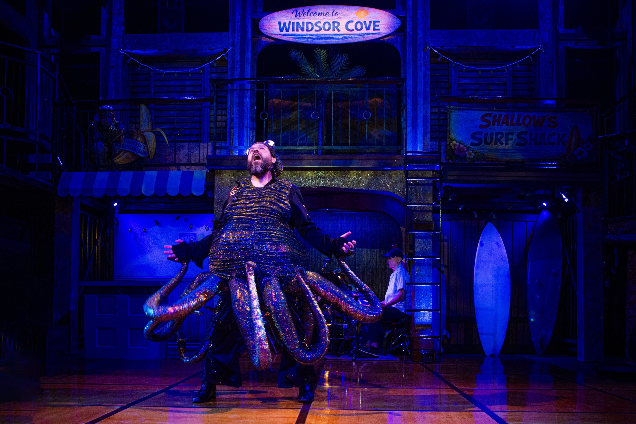 A heightened comic disguise scene uses the architecture as a theatrical frame.