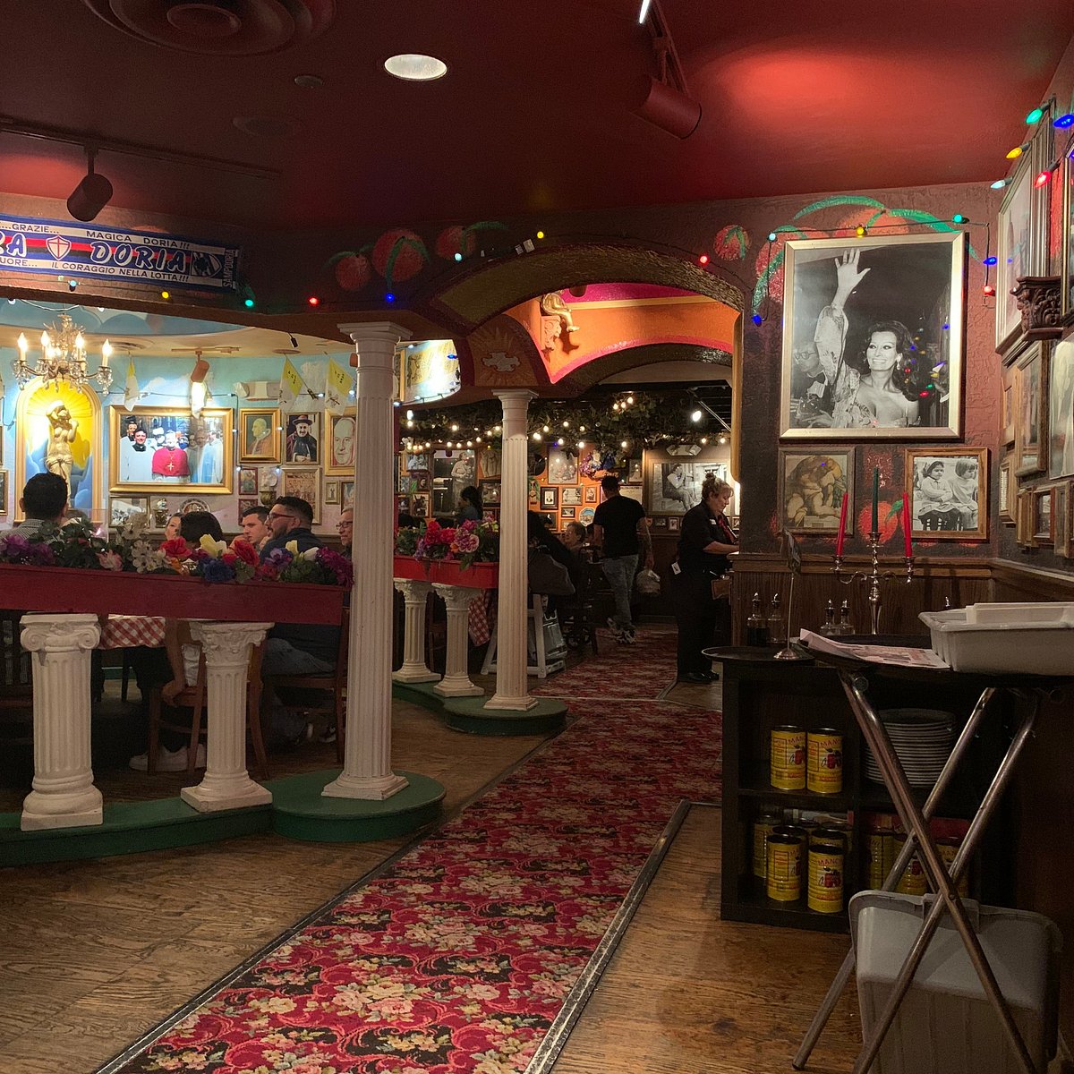 Dining room at Buca di Beppo in Brea with maximalist wall decor and Italian-American set dressing.