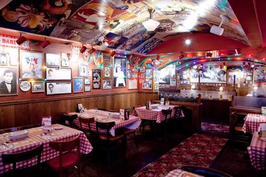 Close detail of kitschy Italian-American decor and framed imagery at Buca di Beppo.