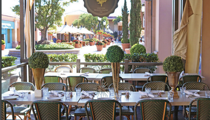 Dining seating at Great Maple with warm, upscale, midcentury-inspired design details.