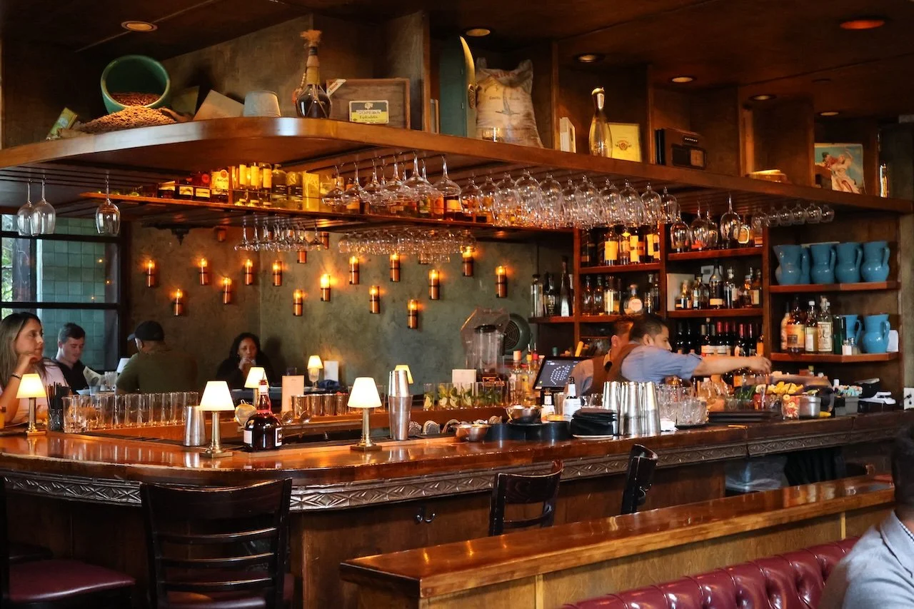 Habana bar area with warm color, decorative lighting, and lush atmospheric details.
