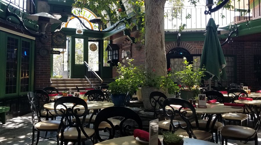 Brick courtyard at Muldoon's Irish Pub with outdoor seating and warm pub atmosphere.