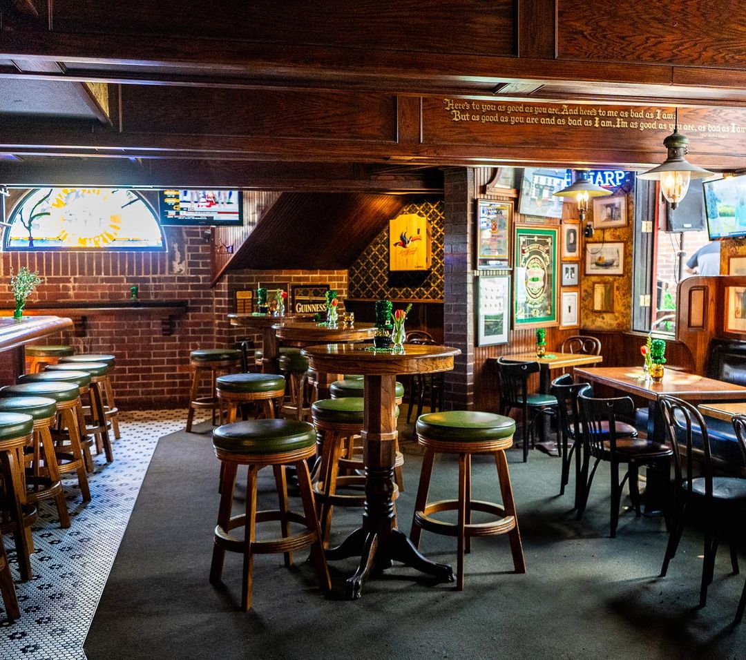 Close detail of brick, wood, stained glass, signage, fireplace, or pub set dressing at Muldoon's Irish Pub.