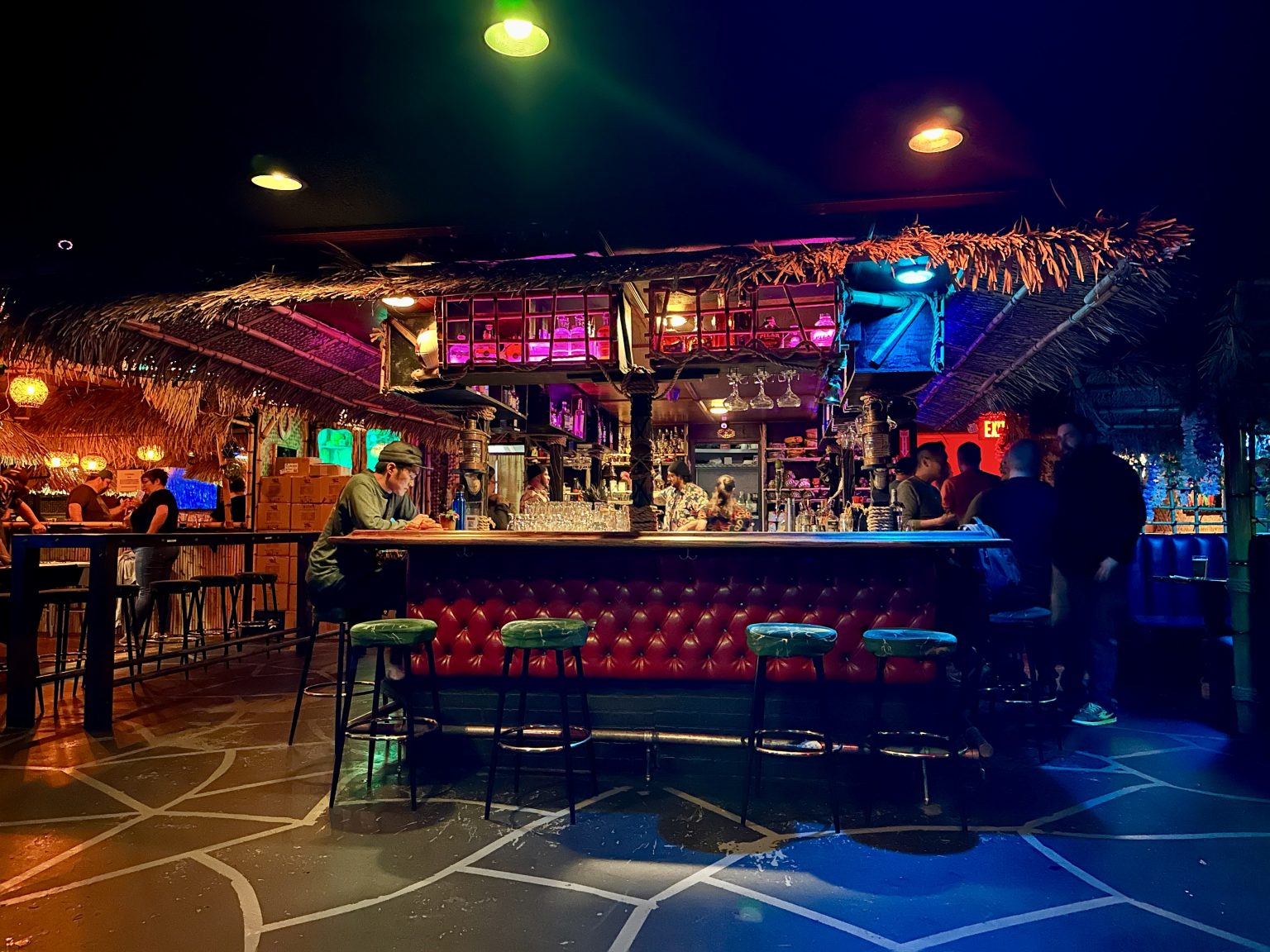 Tiki-inspired restaurant interior with layered decor, warm lighting, and immersive themed details.