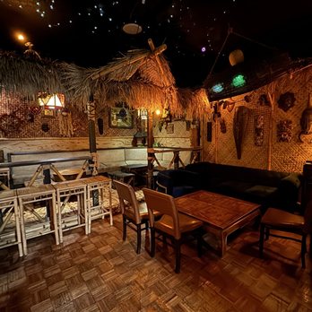 Bamboo booth structures inside STOWAWAY creating intimate seating zones.