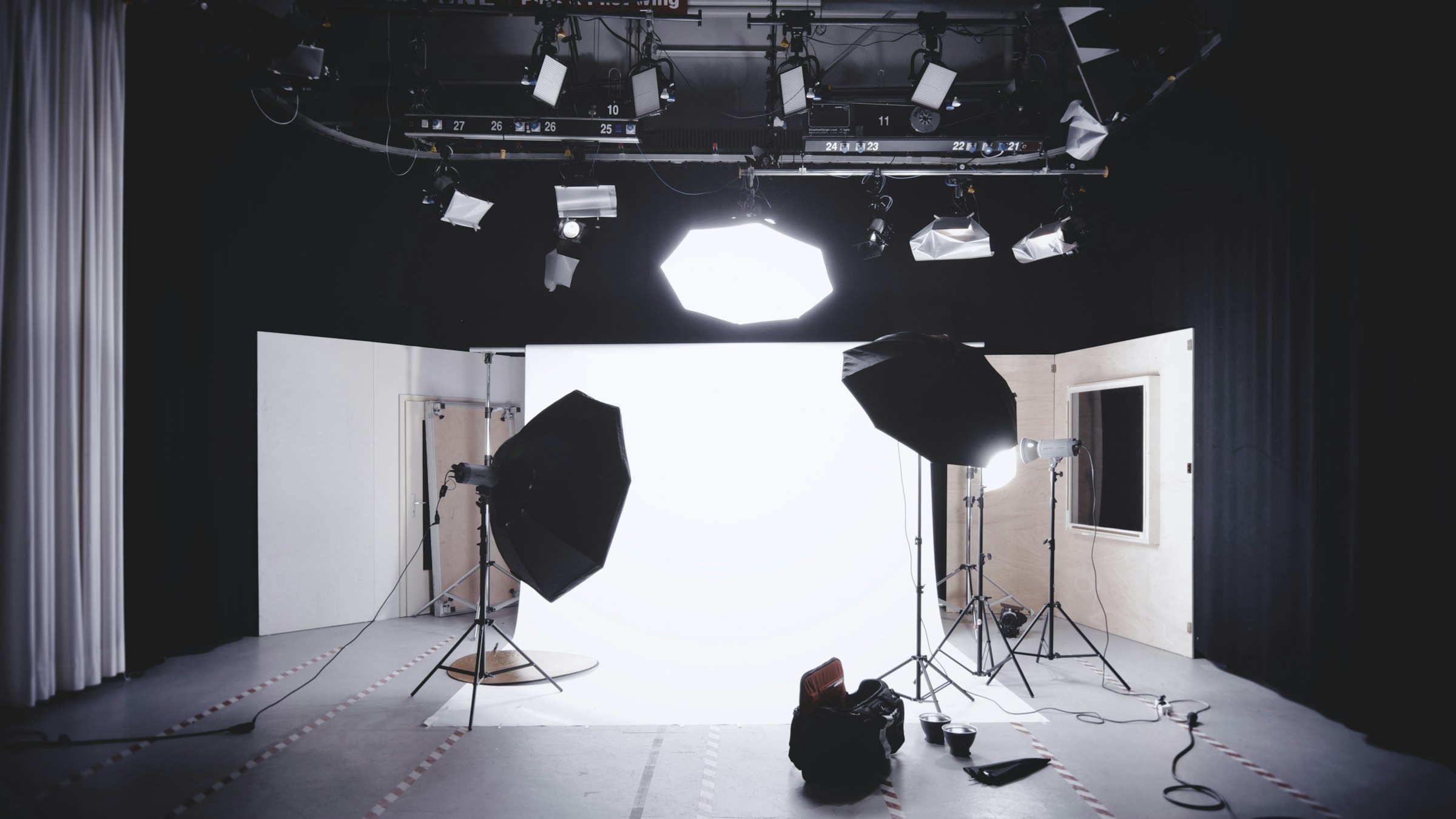 Film production lighting and studio equipment arranged for a shoot.